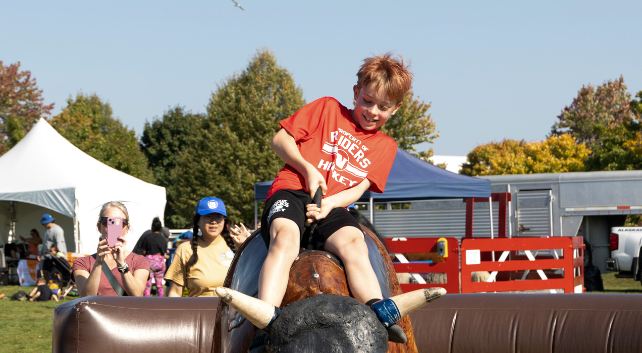 Child riding the mechanical bull.