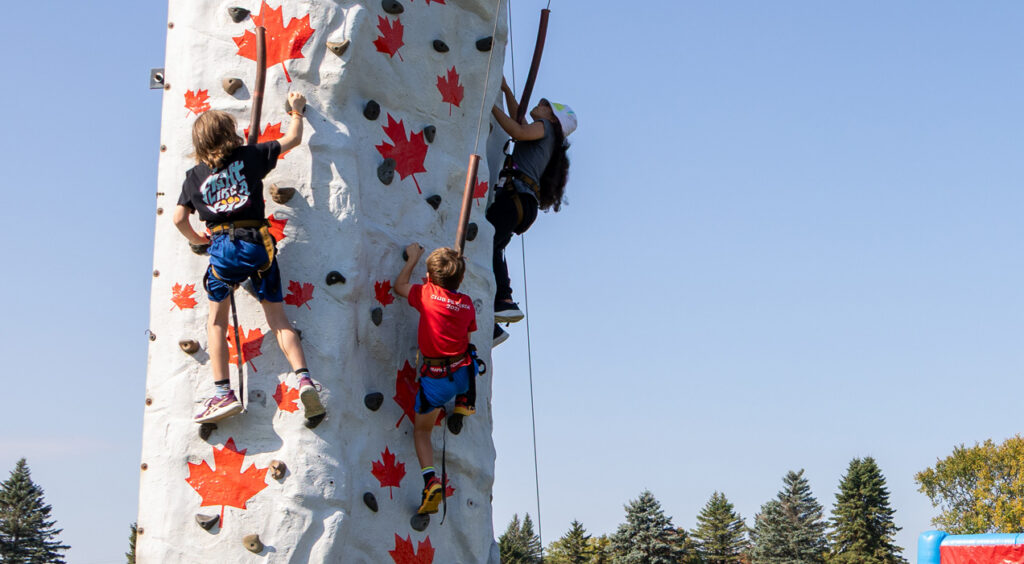 Children climbing the rock climbing wall.